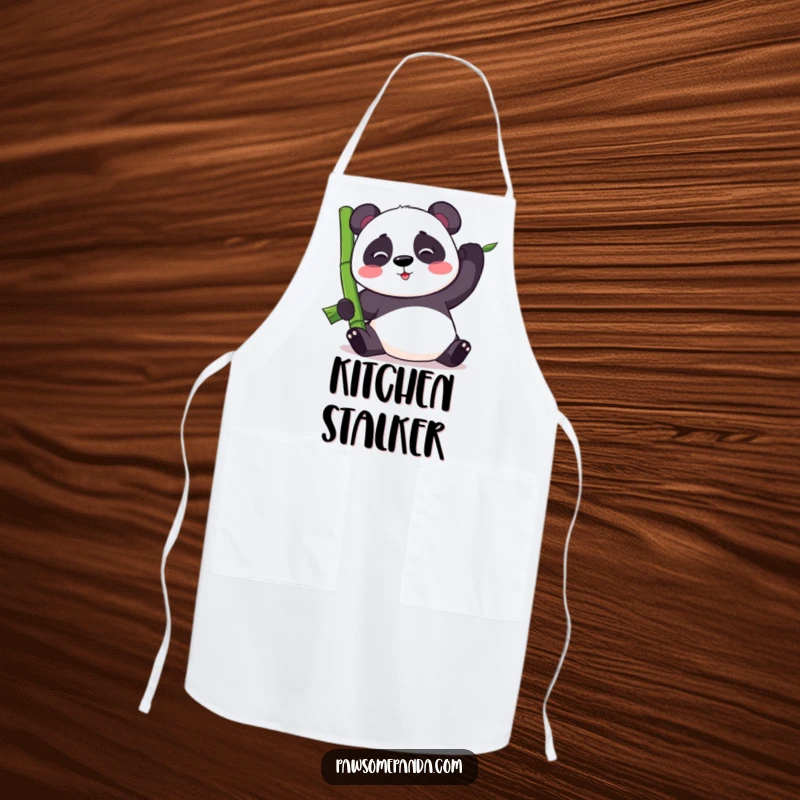 Funny kawaii panda bear balancing a large bamboo stalk, on a kitchen apron, bringing humor to cooking and food prep.