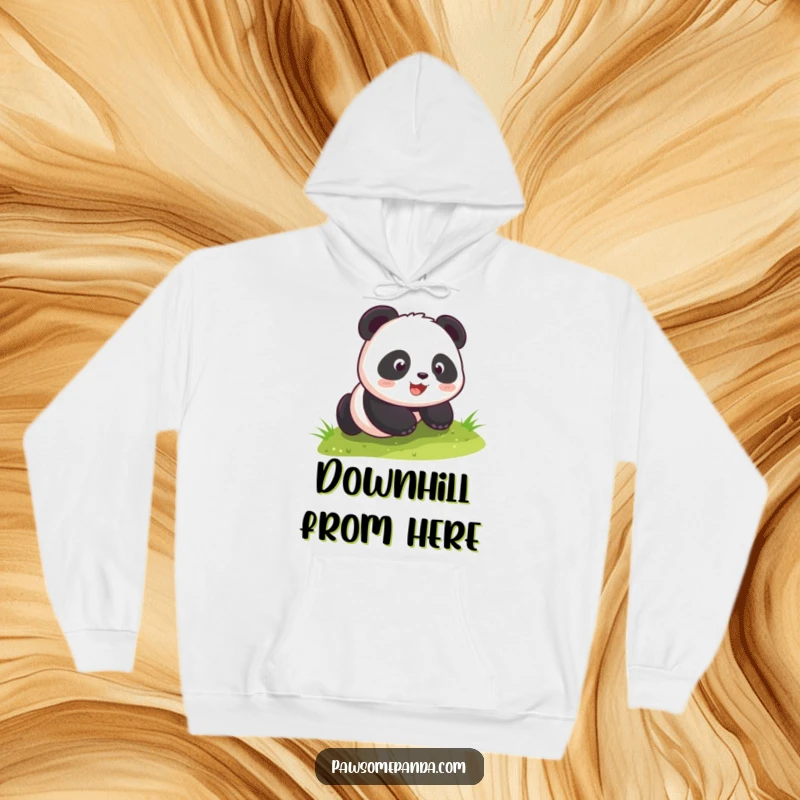 Funny kawaii panda cub gleefully rolling down a grassy slope, featured on a cozy hoodie, radiating warmth and playful energy.
