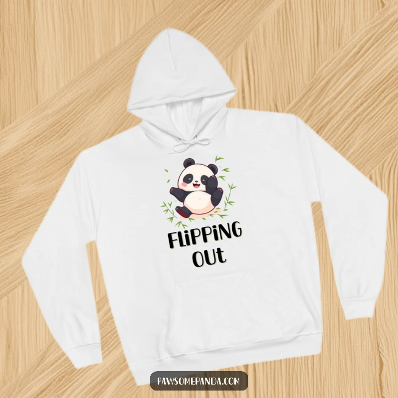 Funny hoodie showing a round panda mid-somersault with scattered bamboo leaves, offering warmth and joy.