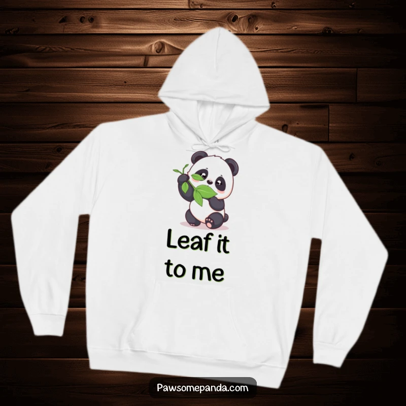 Funny panda playfully bamboozling a leaf on a cozy hoodie, perfect for charming humor.