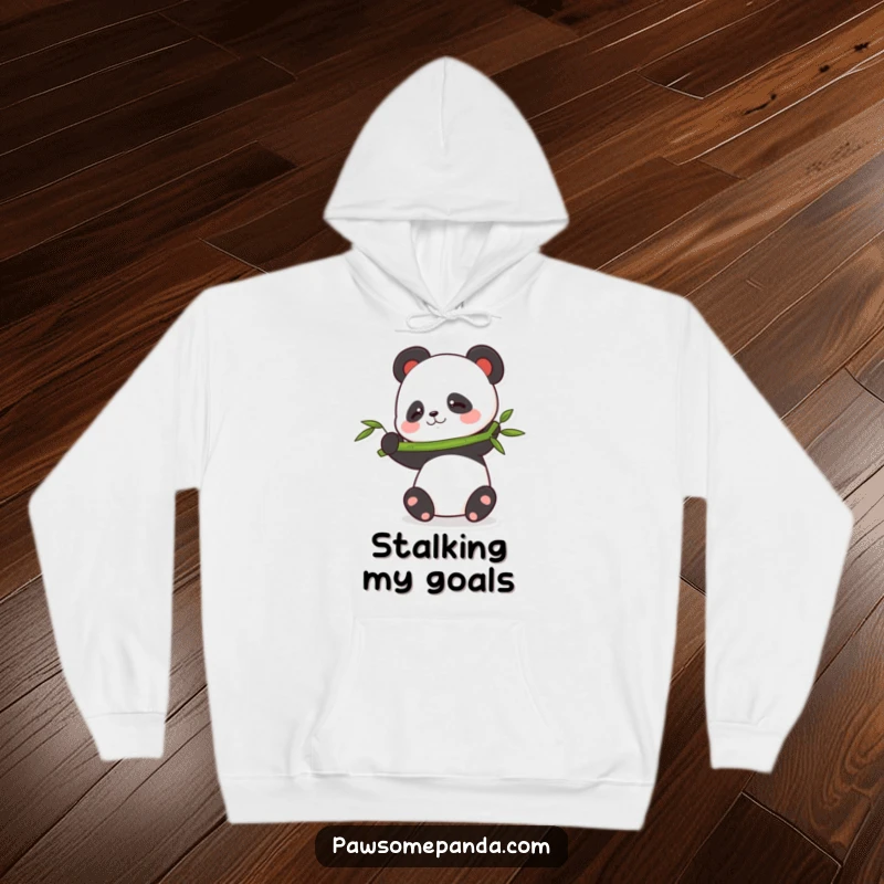 Funny balancing panda hoodie featuring a cute panda character trying to balance a large bamboo stalk, looking focused yet amusing.